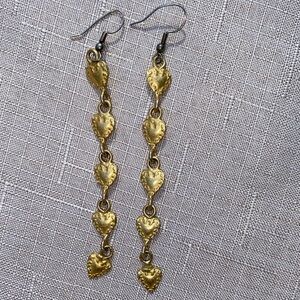 Gold toned metal long pierced heart earrings